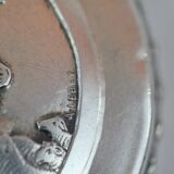 Small round box with silver pills