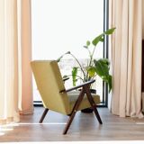 Vintage armchair in moss green bouclé design by H. Lis.