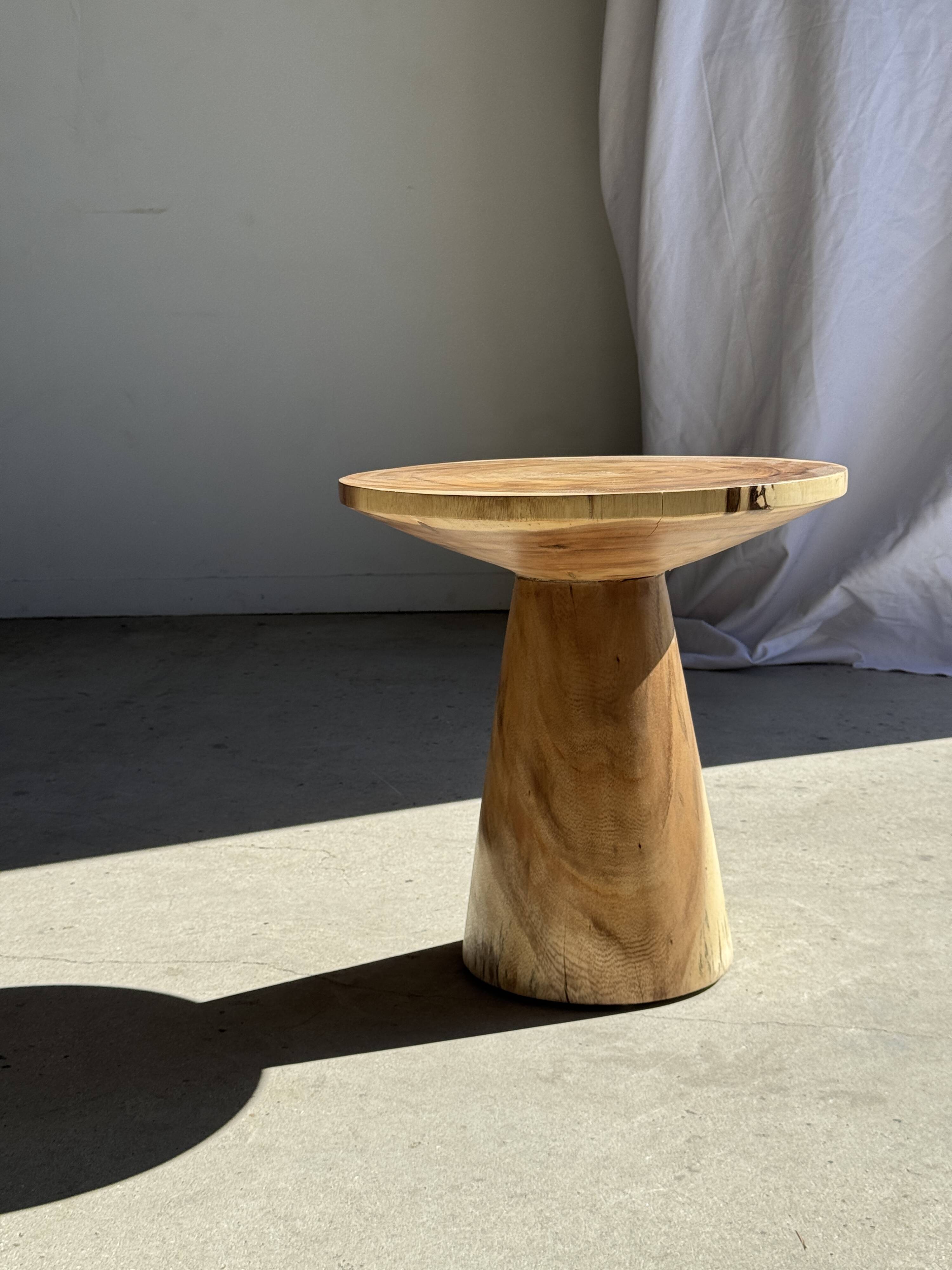 Natural solid suar side table (monoxyle) with a minimal conical base.