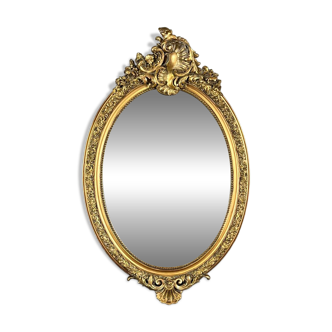 Oval gilded wooden mirror in Louis XV style, 19th century