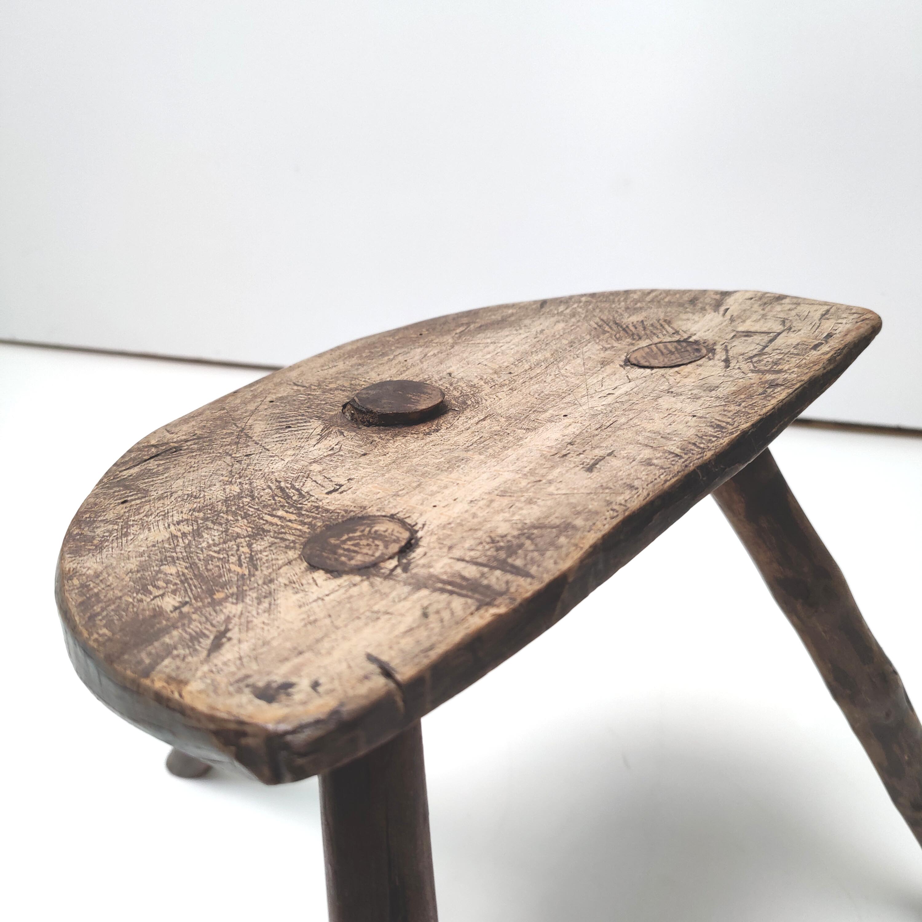 Brutalist tripod stool in solid wood half round