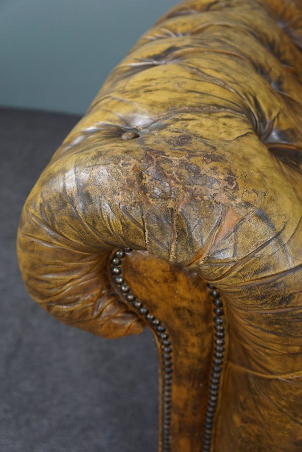 Patinated Chesterfield armchair