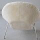 Womb Chair and Ottoman in fluffy white fabric by Eero Saarinen