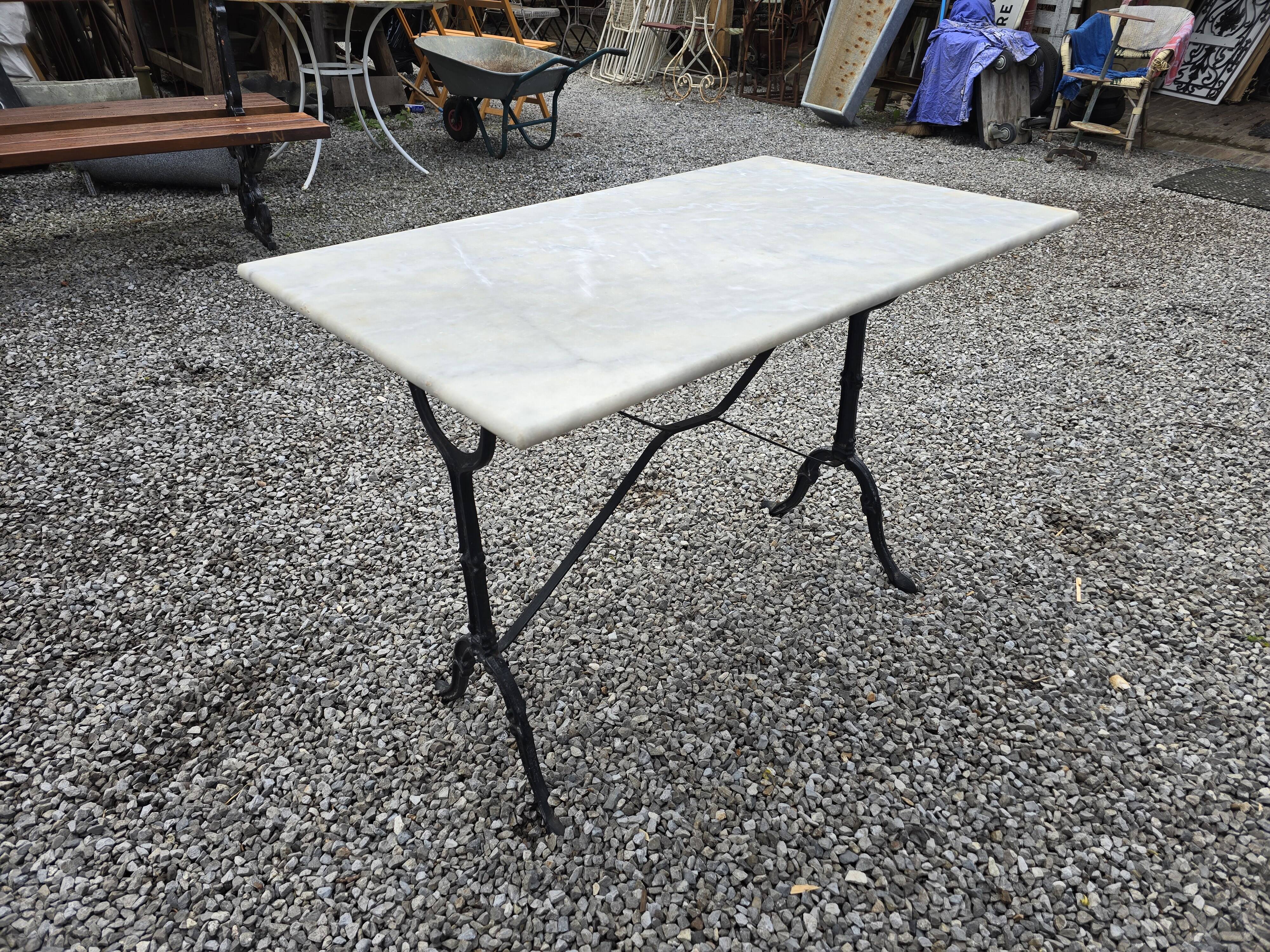 Bistro table with marble top and cast iron base