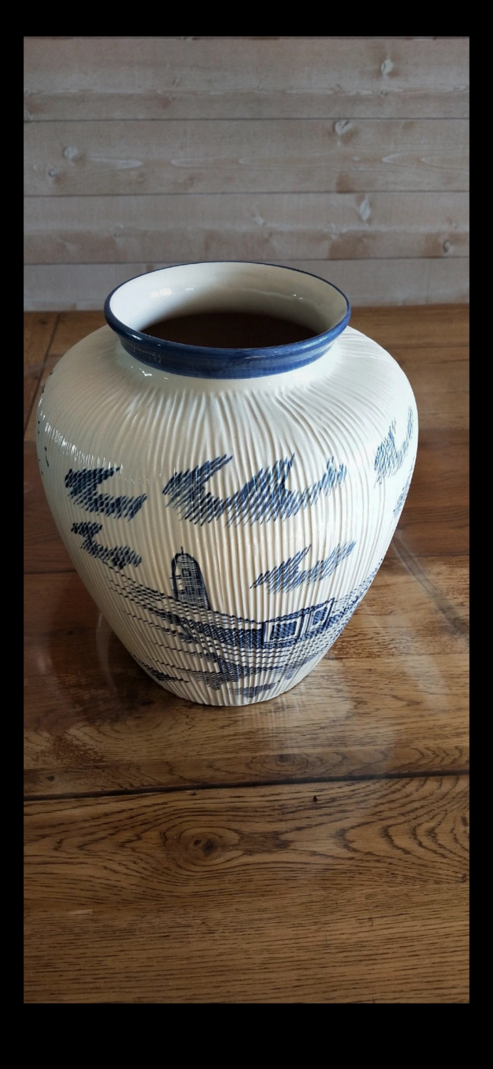 Large terracotta vase covered with ceramics