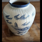 Large terracotta vase covered with ceramics