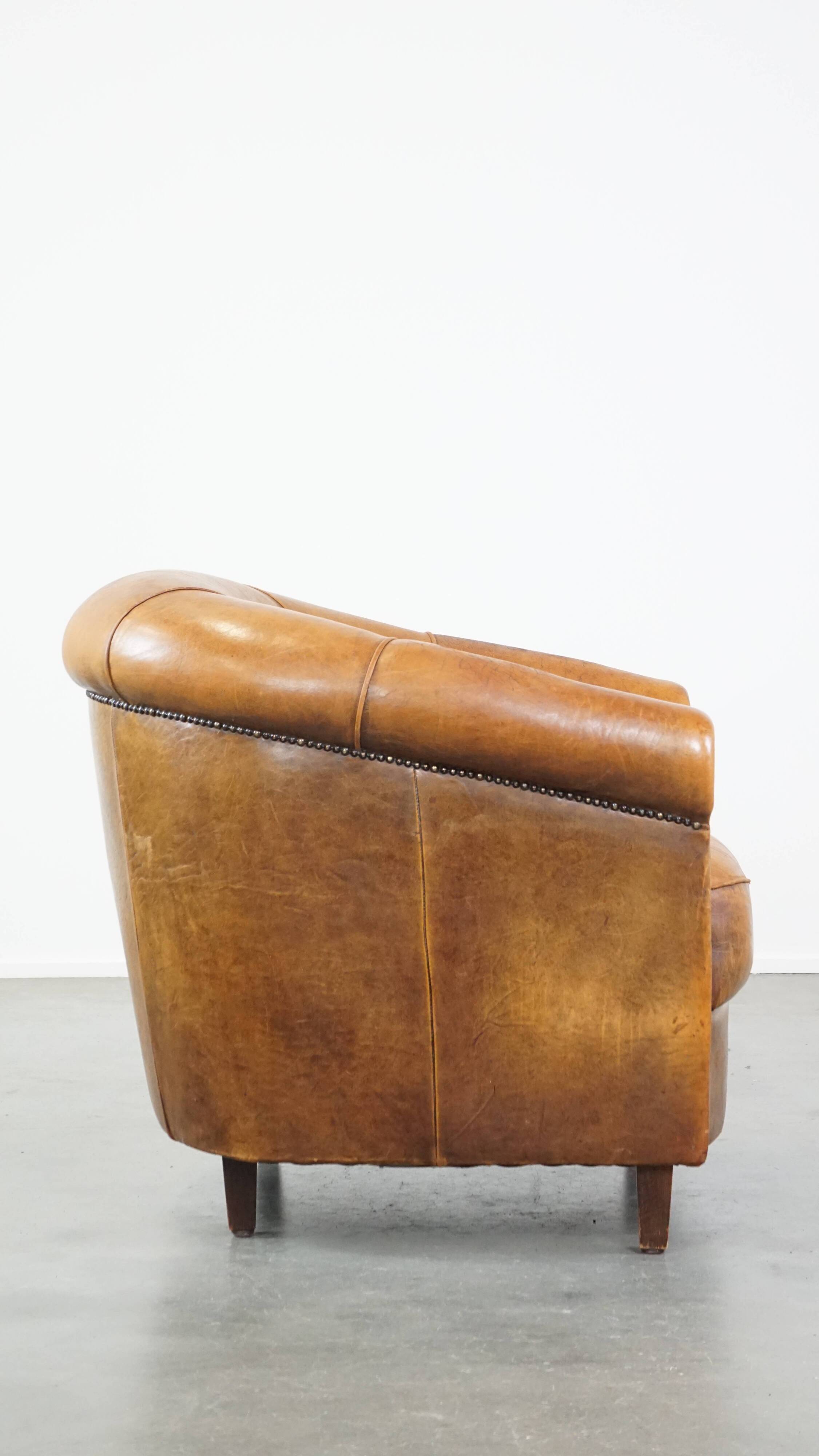 Cognac-colored sheep leather club chair with patina