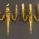 Pair of gilt bronze wall sconces with three lights in the Louis XVI style.
