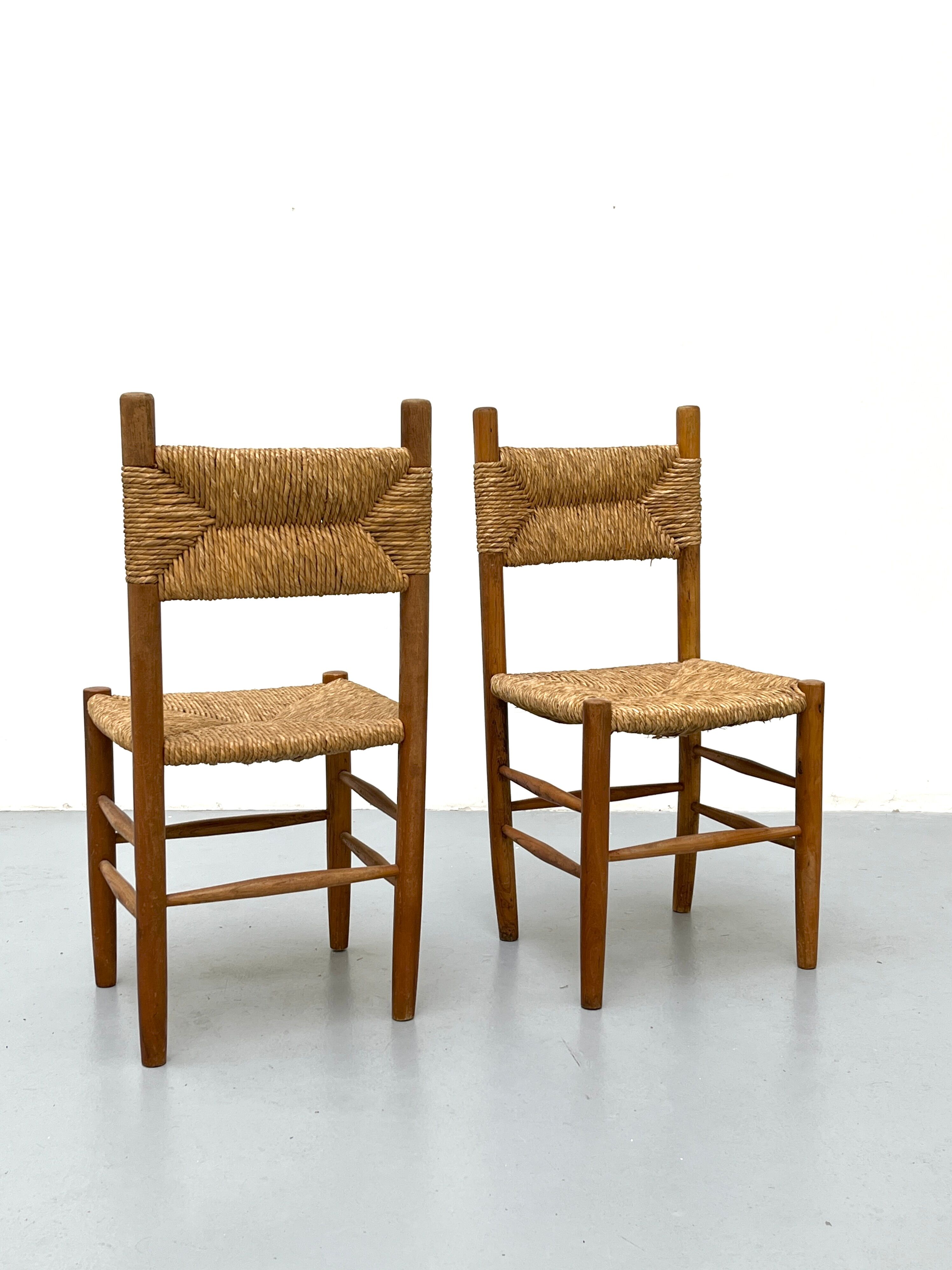 Pair of wooden chairs with seat and straw back