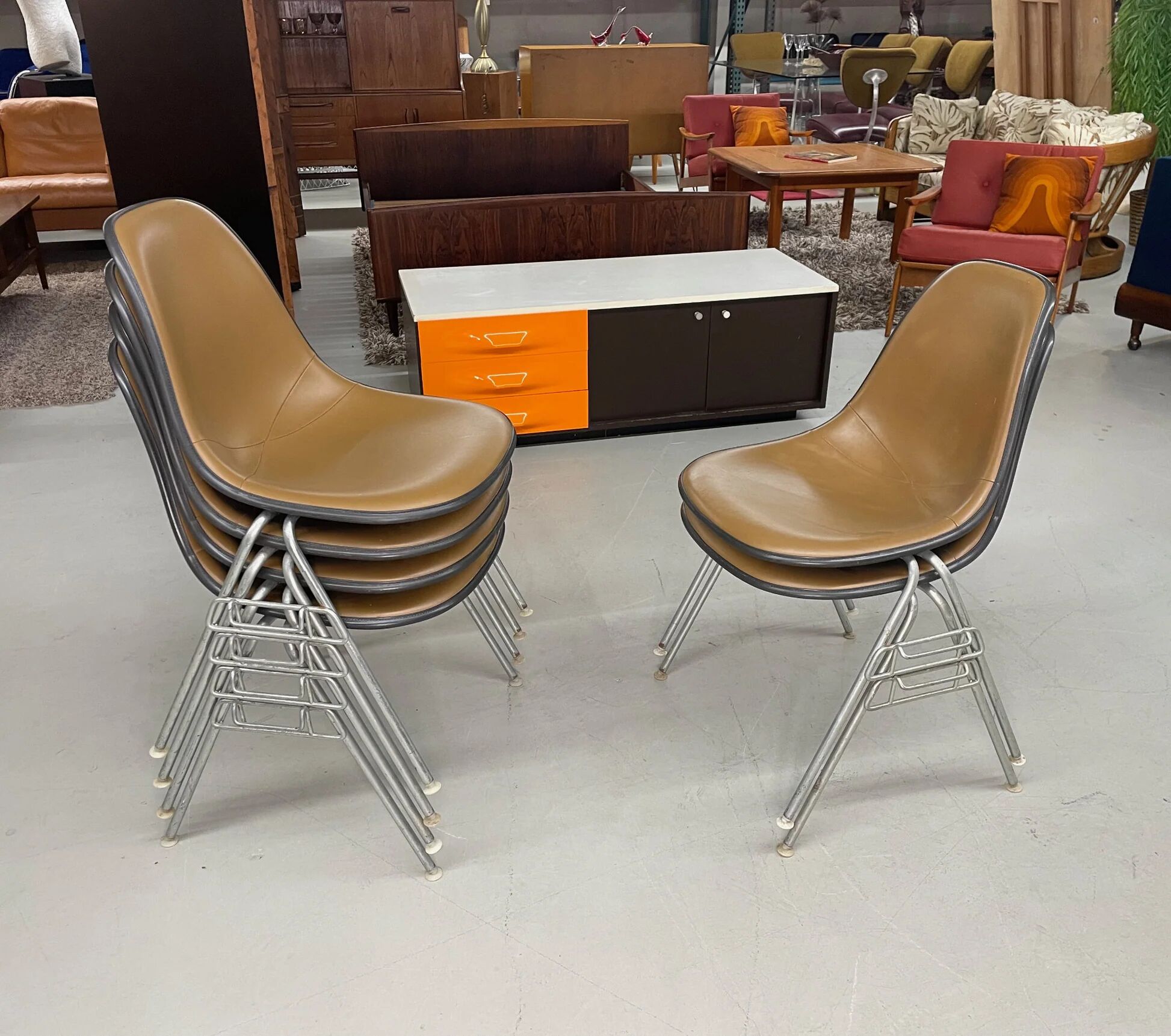 6 Herman Miller Eames stacking shell chairs with brown naugahyde pads