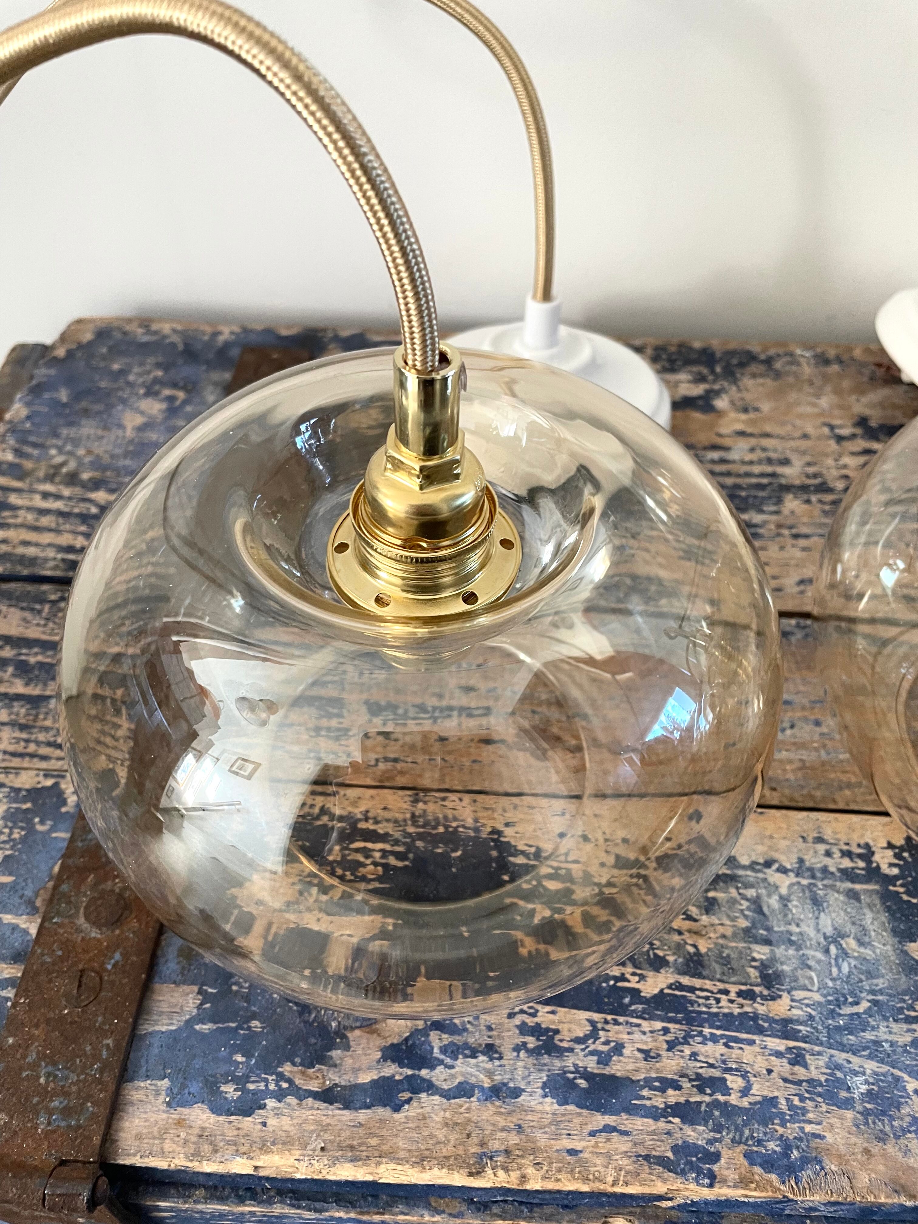 Set of three new electrified golden glass pendant lamps