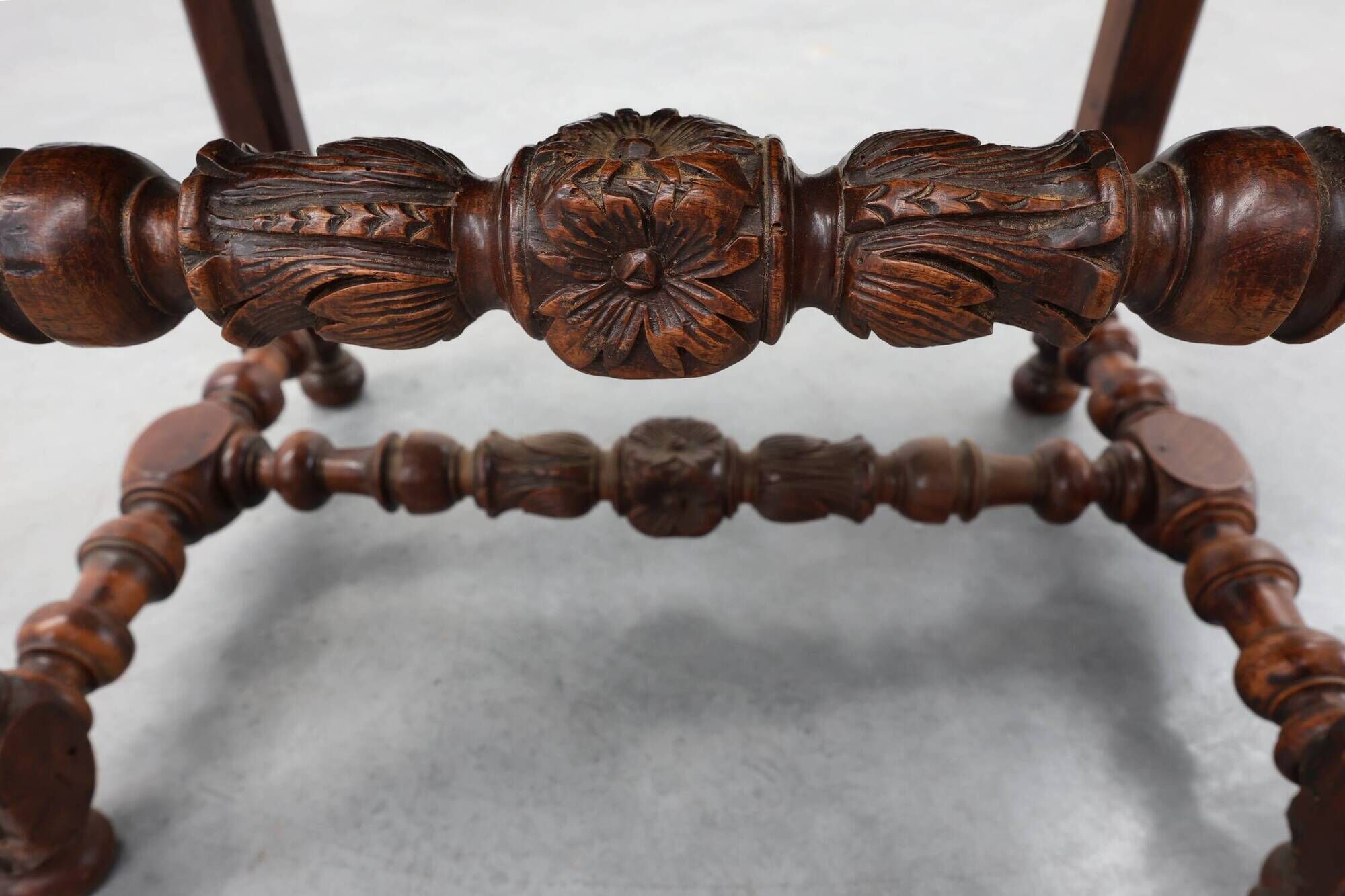 Louis XIII walnut stool with carved turned stretchers and upholstered seat