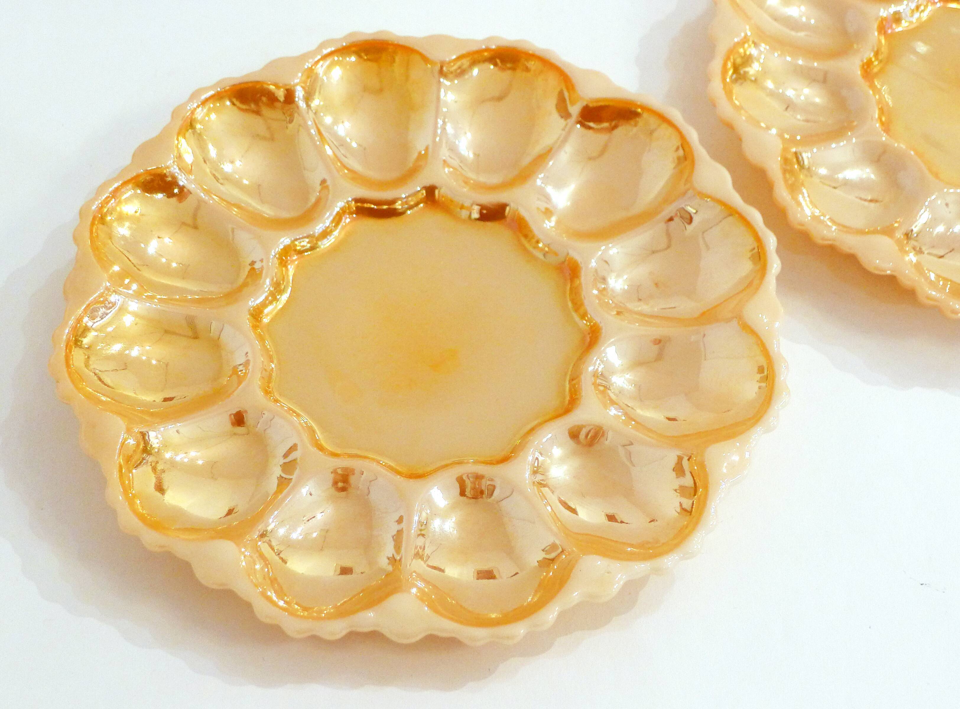 Pair of iridescent orange glass egg plates