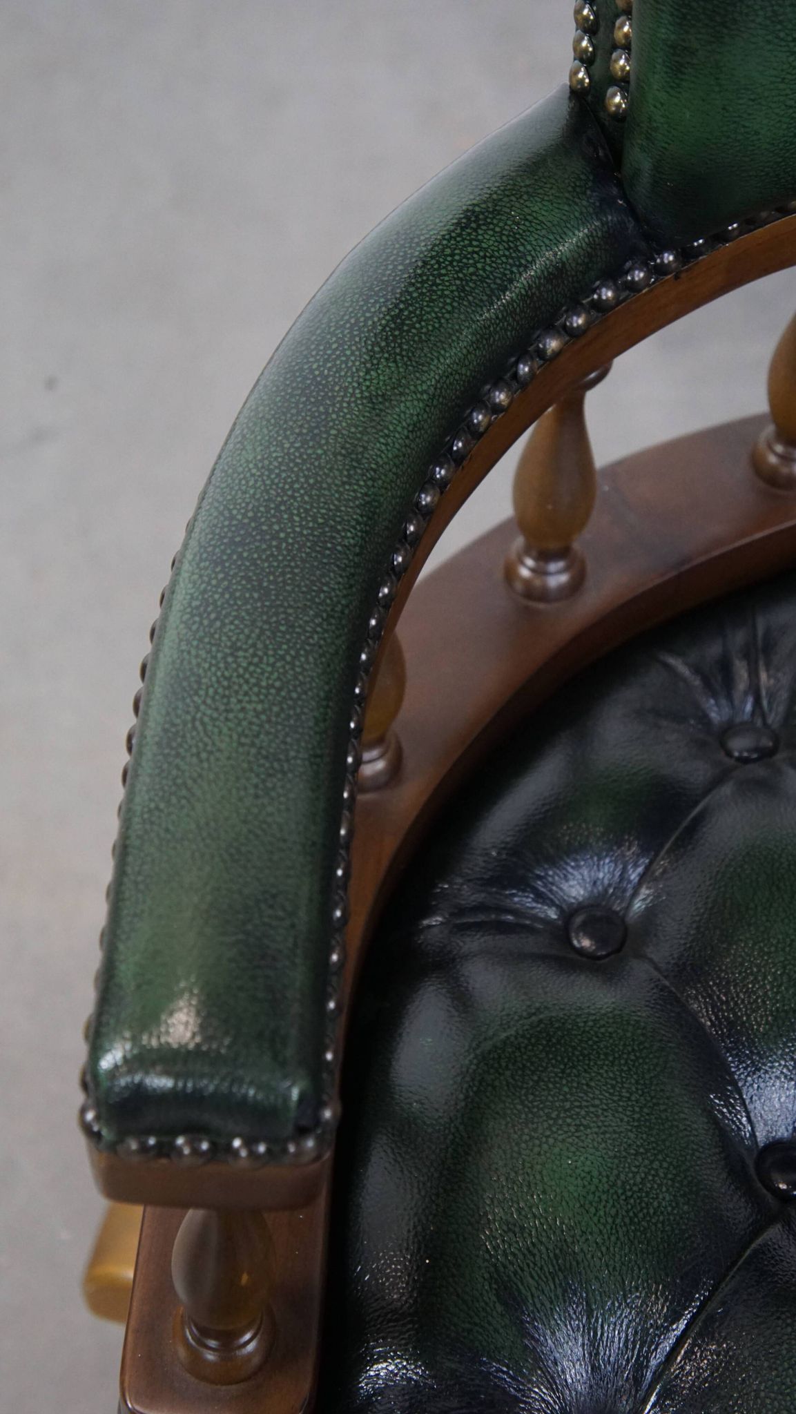 Dark green cowhide leather and wood chesterfield office chair on wheels