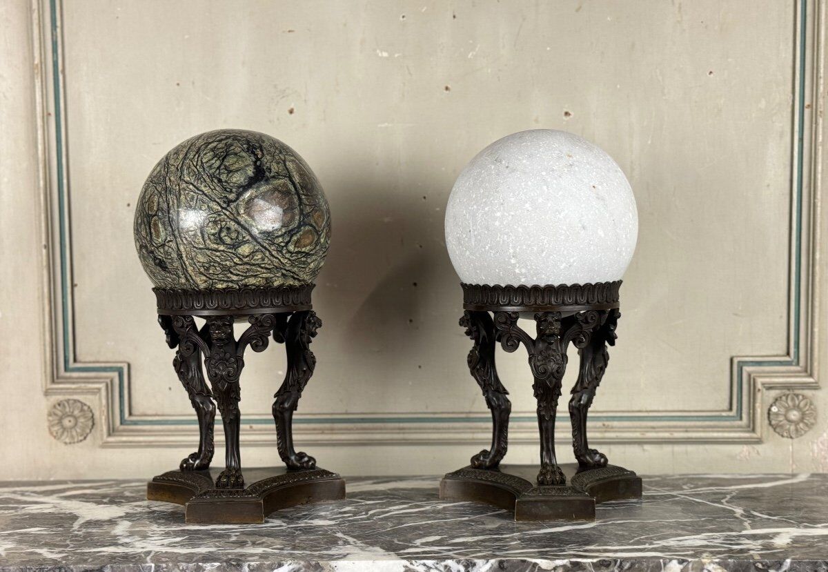 Pair of marble spheres on bronze tripods, 19th century
