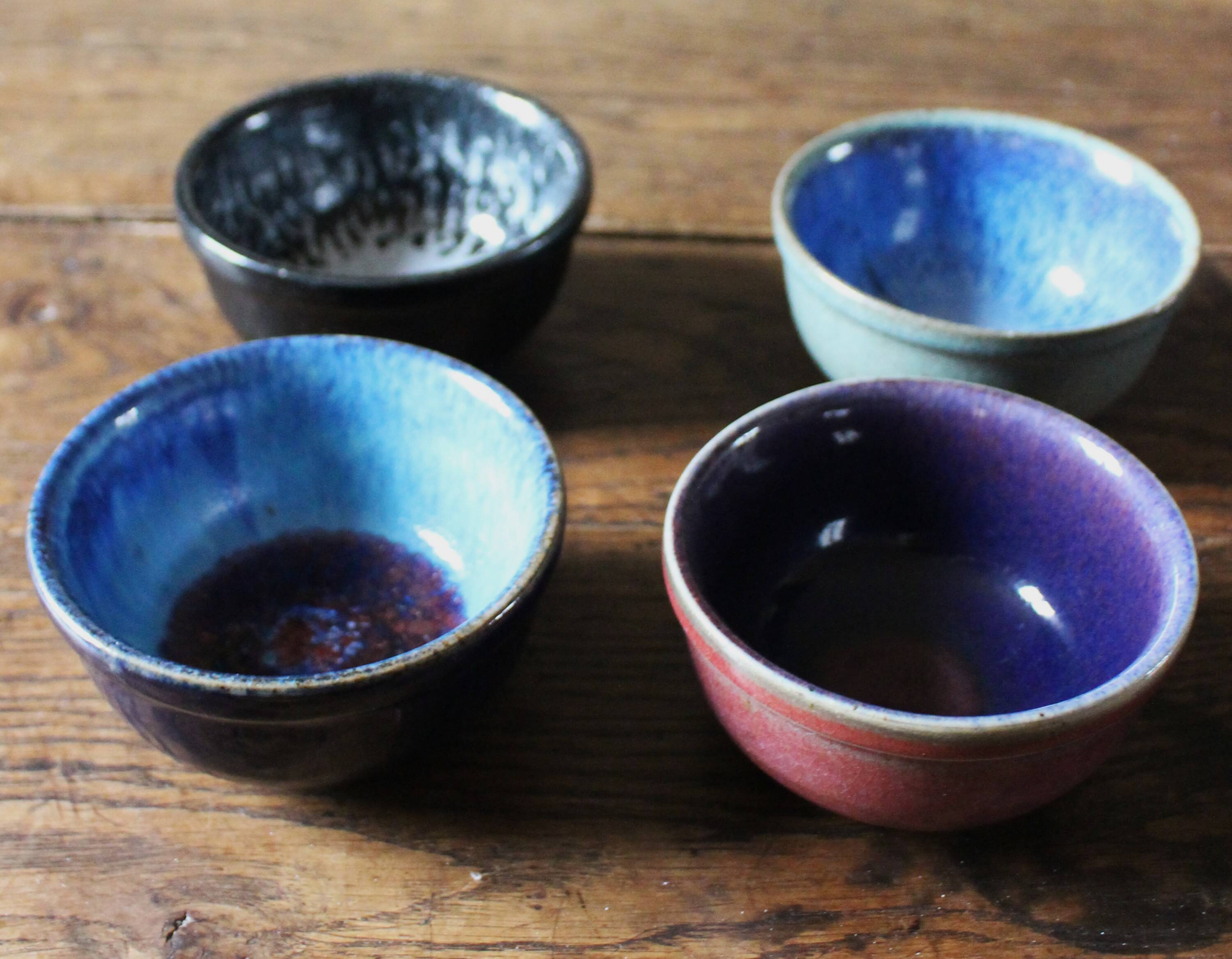 A set of 4 pottery bowls in coloured glaze.