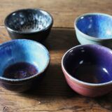 A set of 4 pottery bowls in coloured glaze.