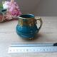 Old small Sadler cream pot in blue-green ceramic with a gold pattern, English milk jug.