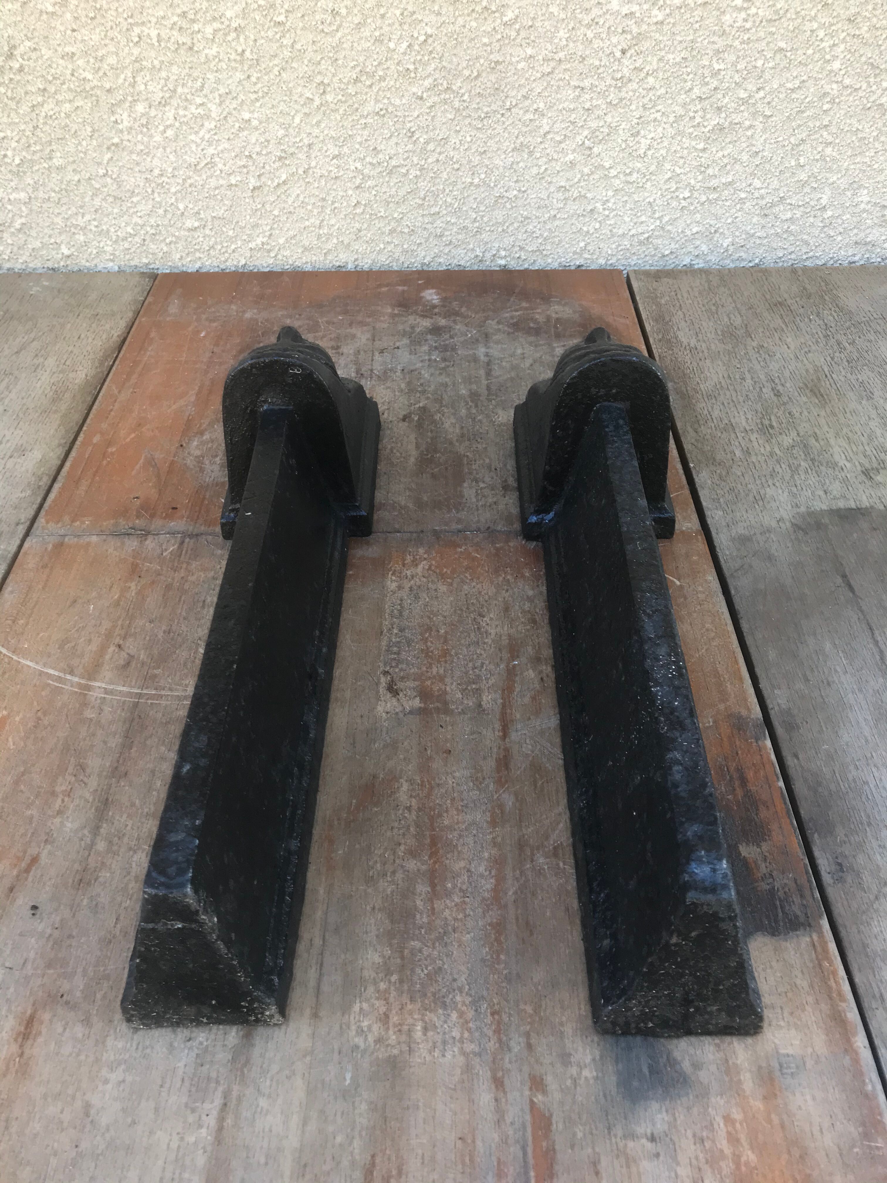 Old pair of chimney caterpillars shape of the head of a woman in iron