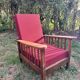 Morris chair with wooden frame and burgundy cushions.