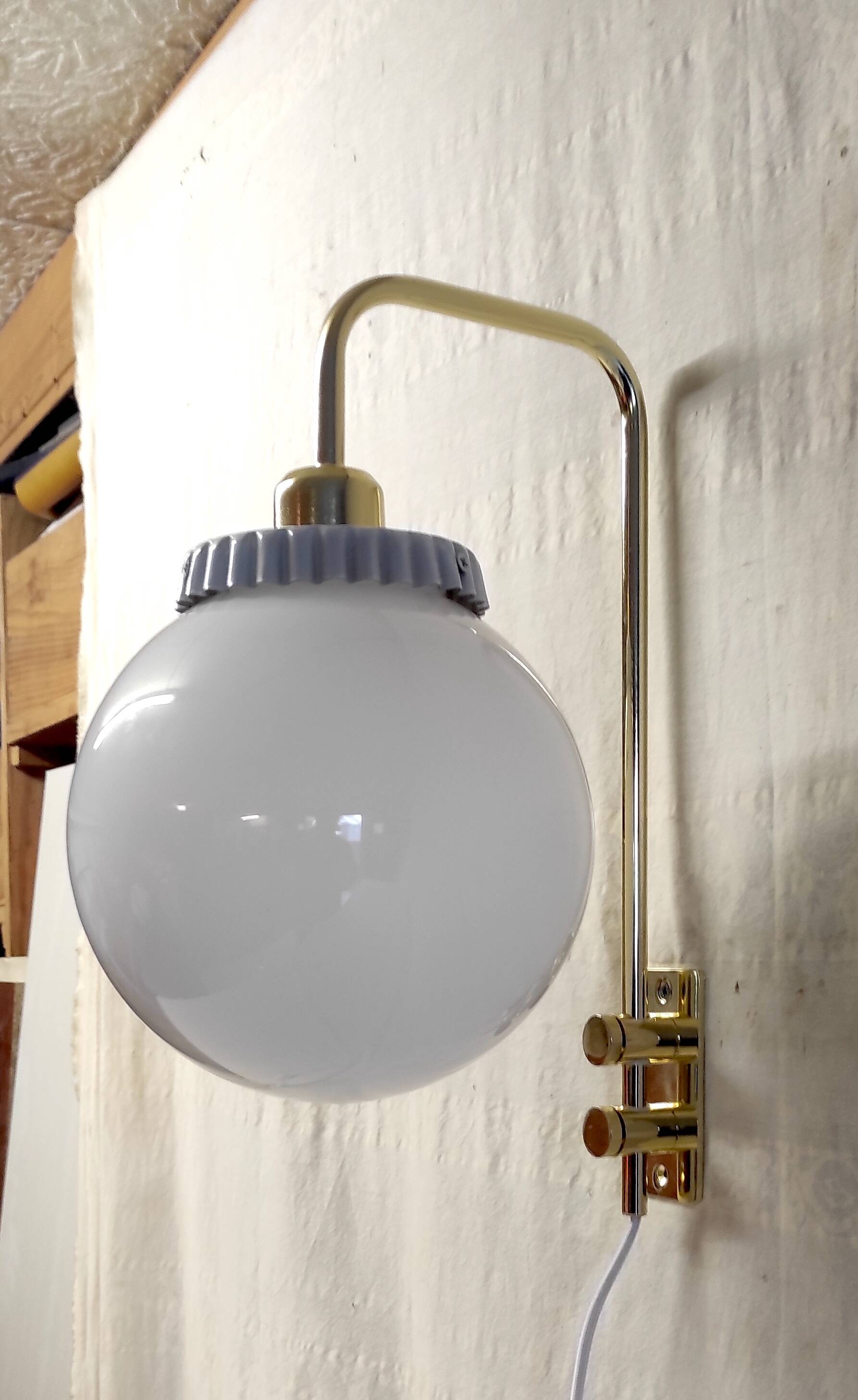 Opaline glass globe wall sconce with a gilt metal bracket - mid-20th century