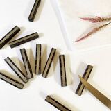 Set of 11 ebony wood knife rests with brass inlay