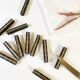 Set of 11 ebony wood knife rests with brass inlay