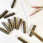Set of 11 ebony wood knife rests with brass inlay