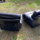 Pair of black imitation leather armchairs