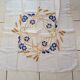 Square tablecloth. Hand-embroidered central crown; the blues.
