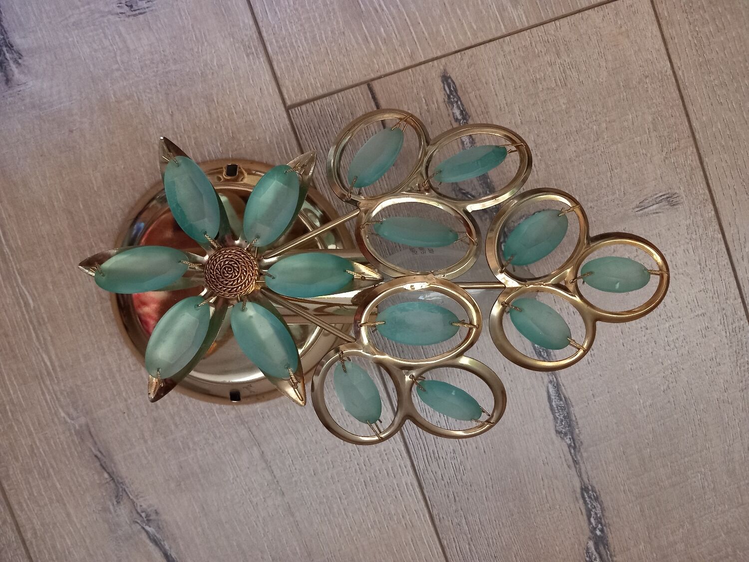 Gold metal wall light with light blue tassels