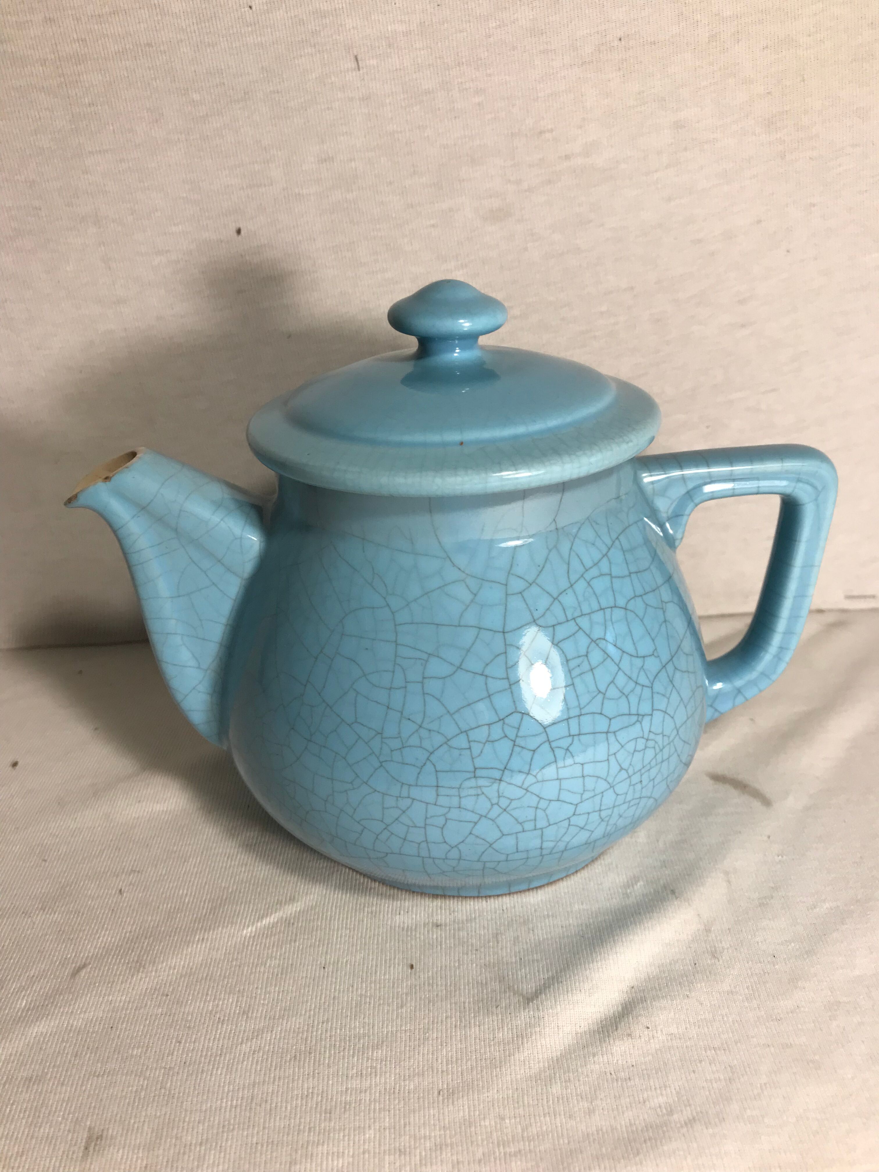 Cracked blue ceramic vintage teapot