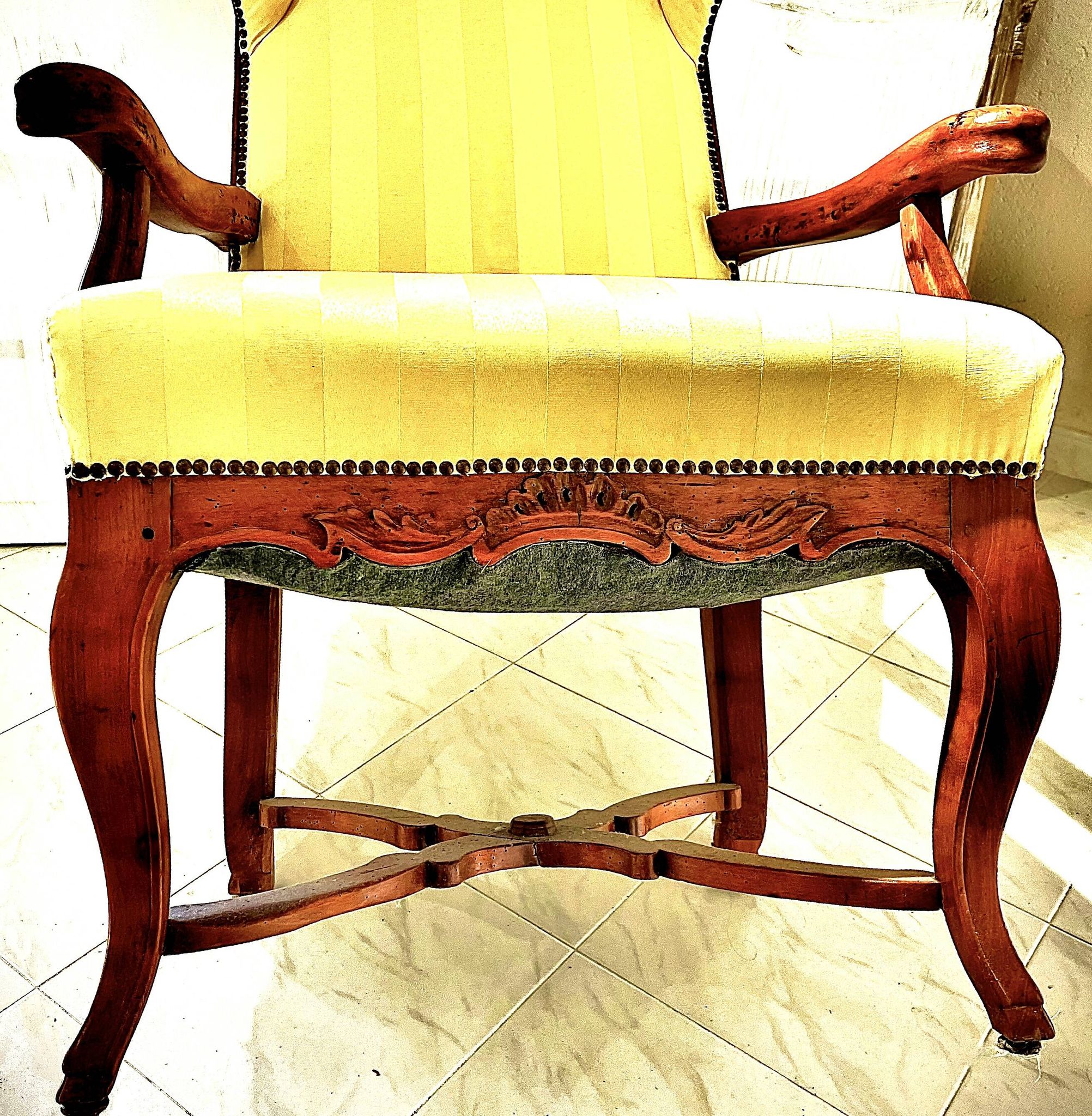 Wingback armchair in walnut in the French Regency style with stretcher in