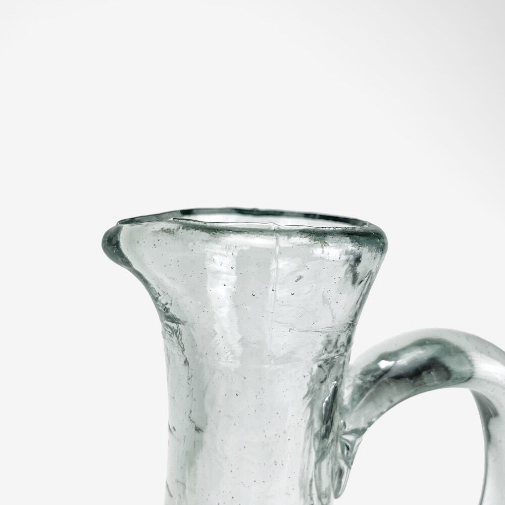 Antique water jug made of thick blown glass