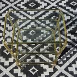 Nested tubular tables in gold metal.