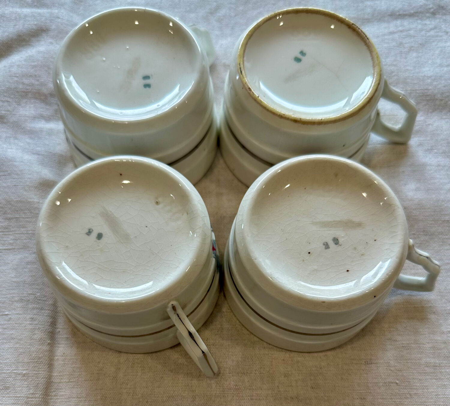Set of 4 fine porcelain coffee cups with floral patterns and silver accents.