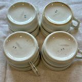 Set of 4 fine porcelain coffee cups with floral patterns and silver accents.