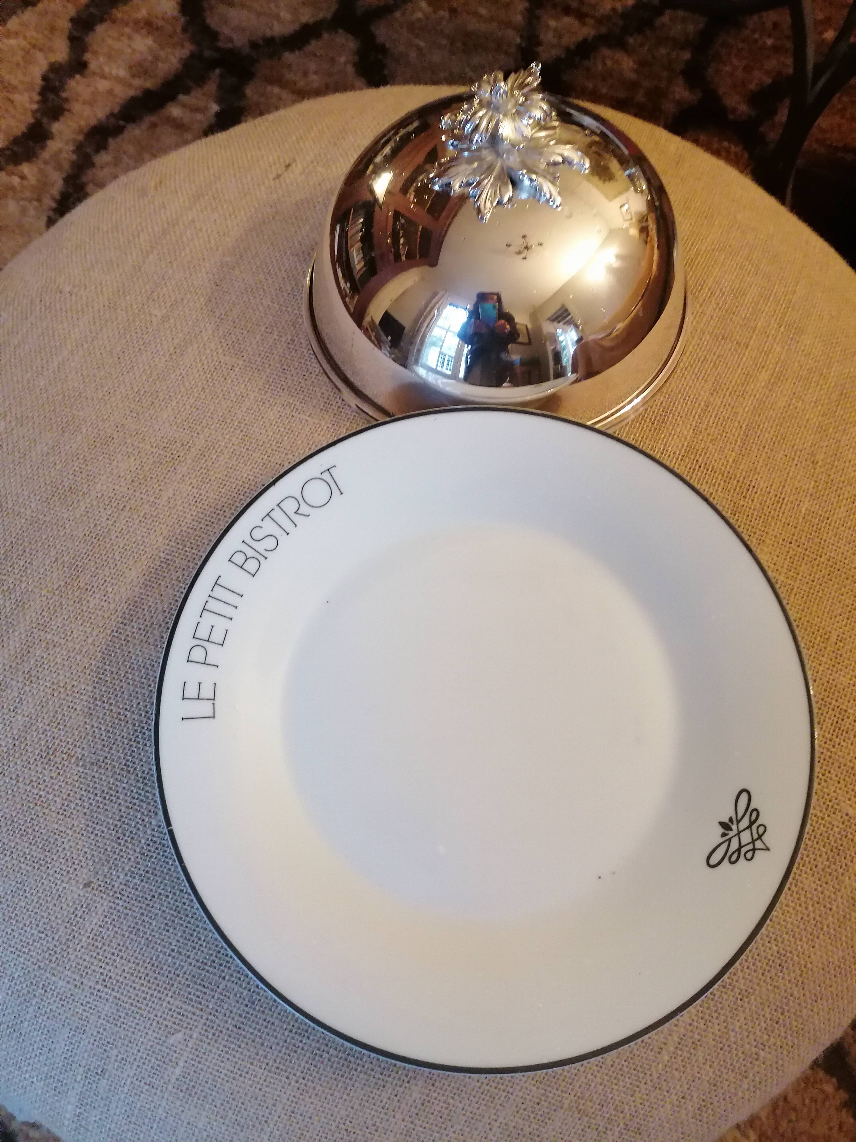 Silver metal bell on its porcelain dish