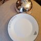 Silver metal bell on its porcelain dish