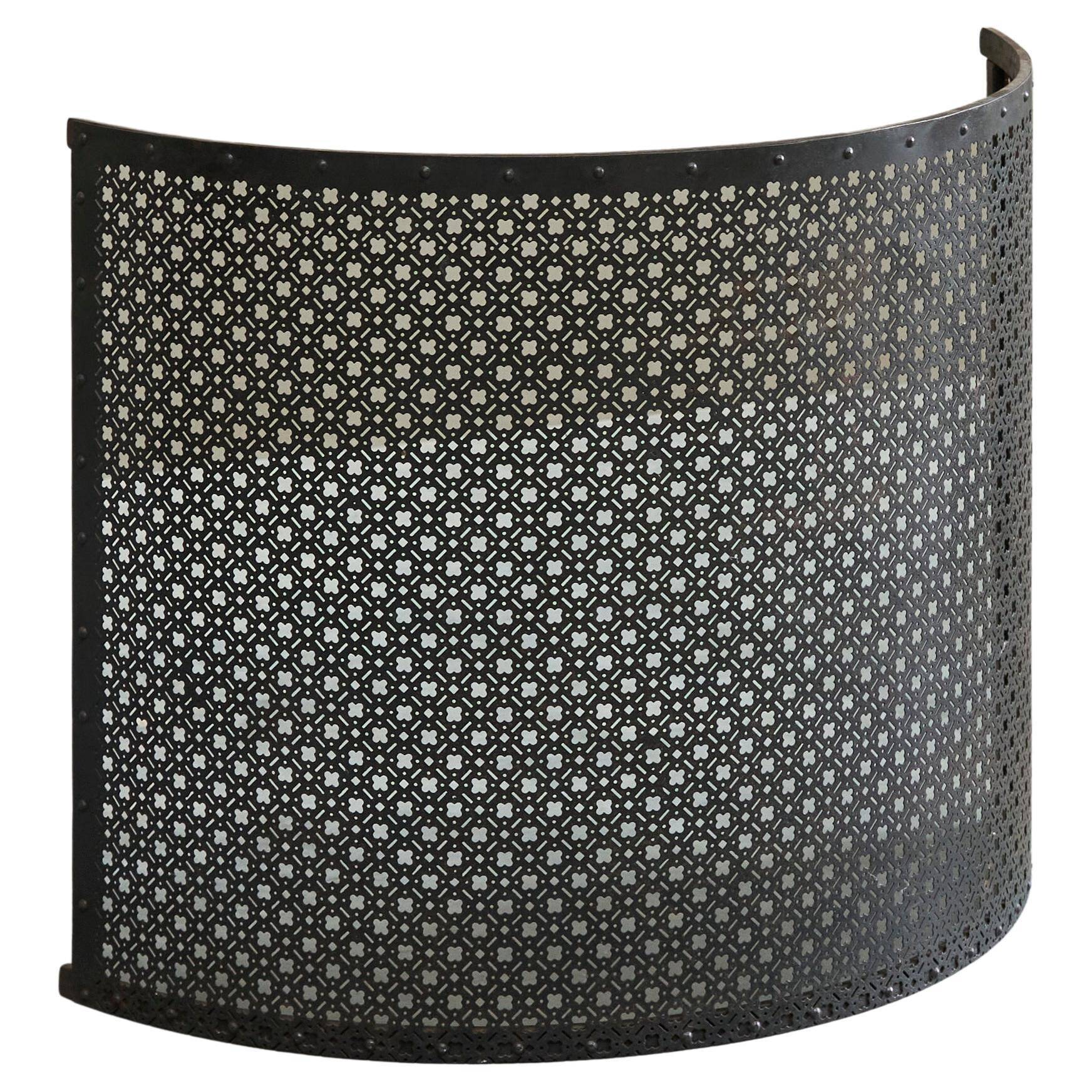 Half-moon antique wrought iron fire screen from the 19th century.