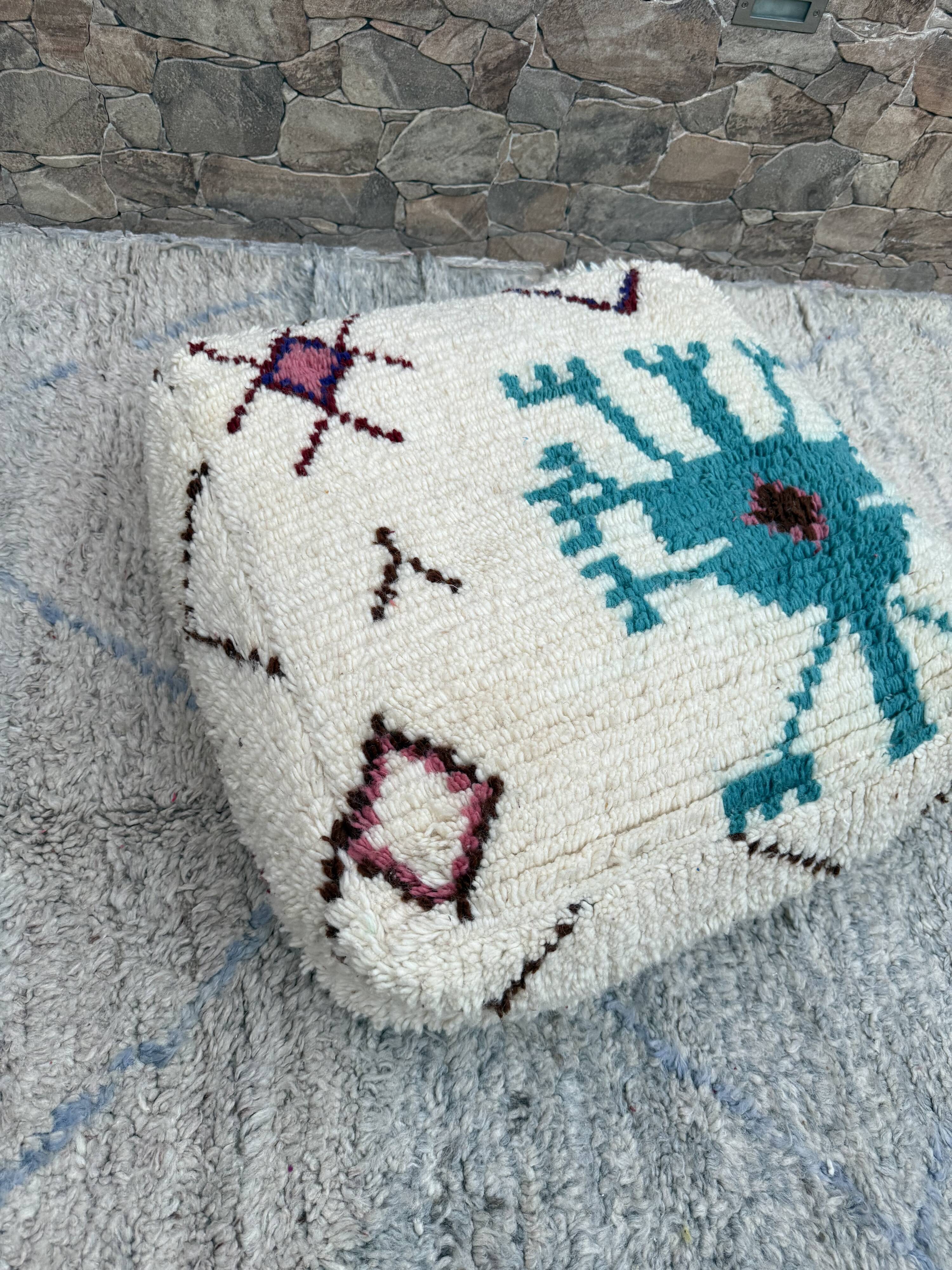 Berber floor pouf: Handwoven Moroccan wool cushion.