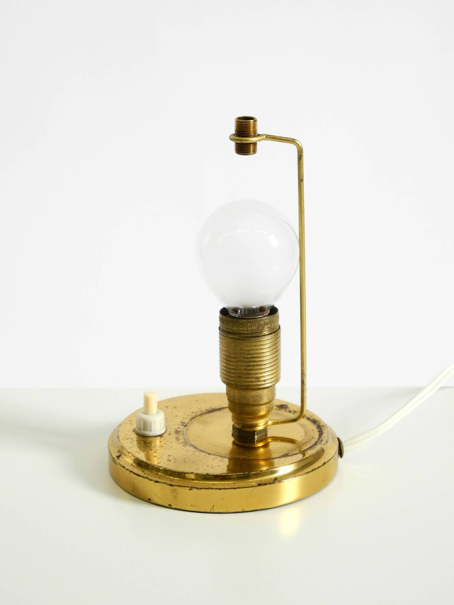 A beautiful, rare 1950s brass table lamp with one opal glass shade adorned