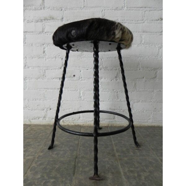 Vintage stool lined with cowhide