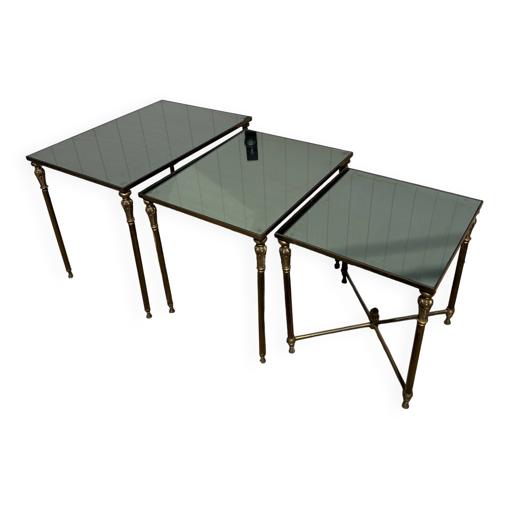 Nested tables in gilded brass in the style of Maison Charles.