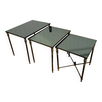 Nested tables in gilded brass in the style of Maison Charles.