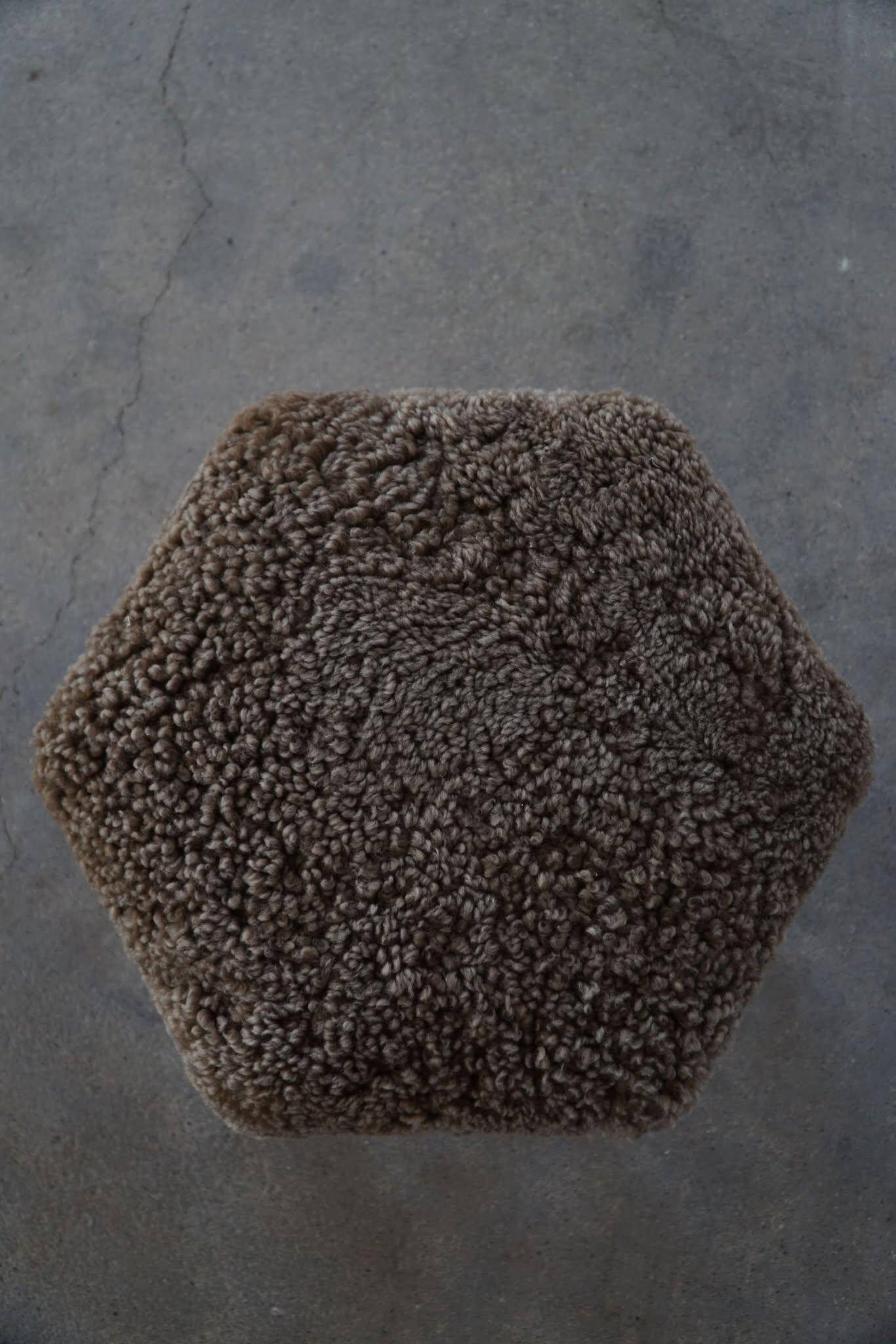 A hexagonal oak stool, seat refurbished in lambswool, Danish design from the 1950s.