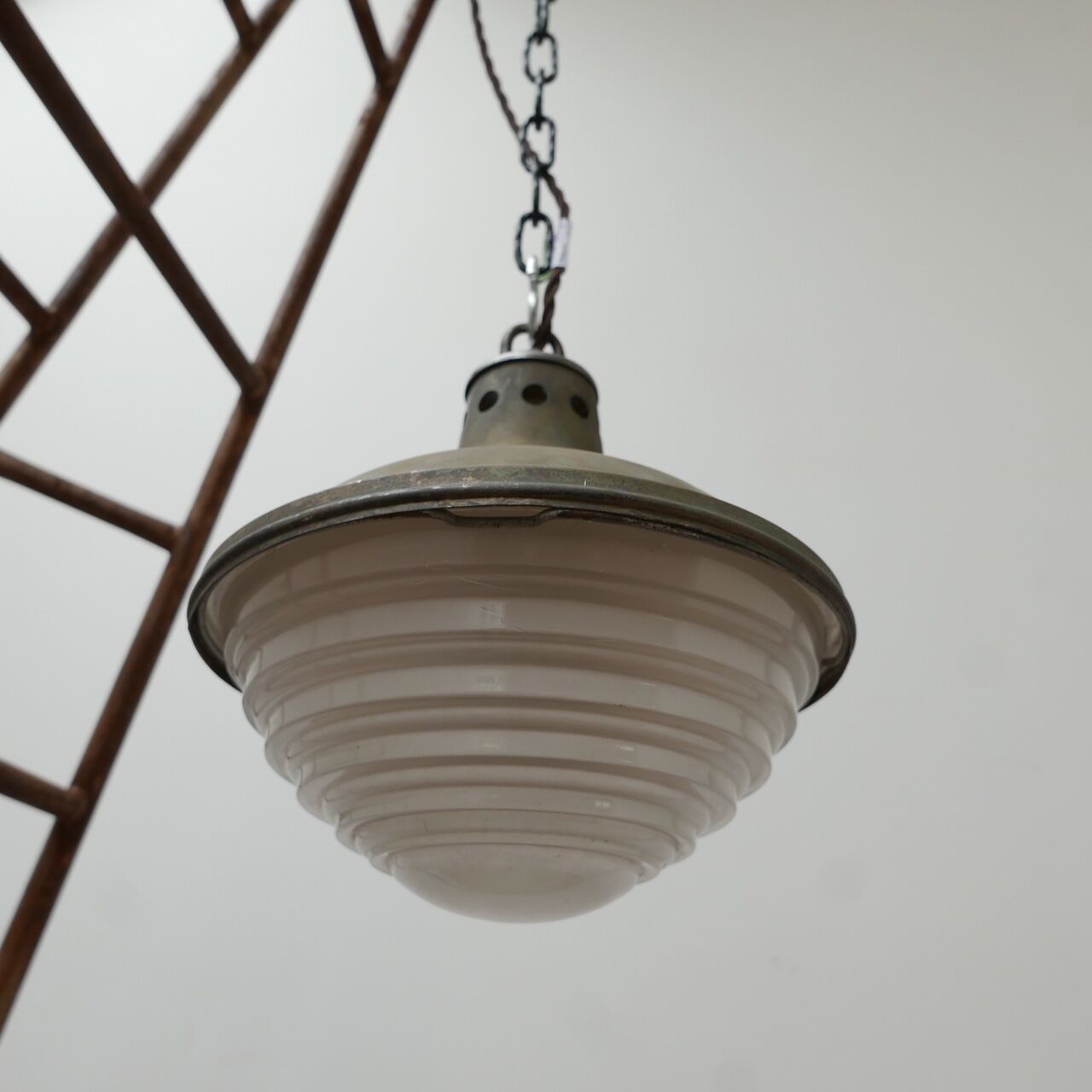 Patinated metal and glass Holophane pendant light
