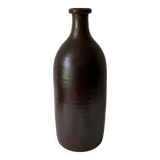 Old bottle in matte brown stoneware