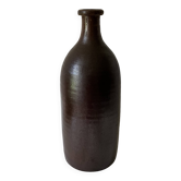 Old bottle in matte brown stoneware