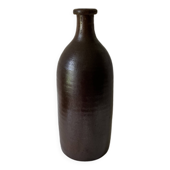 Old bottle in matte brown stoneware